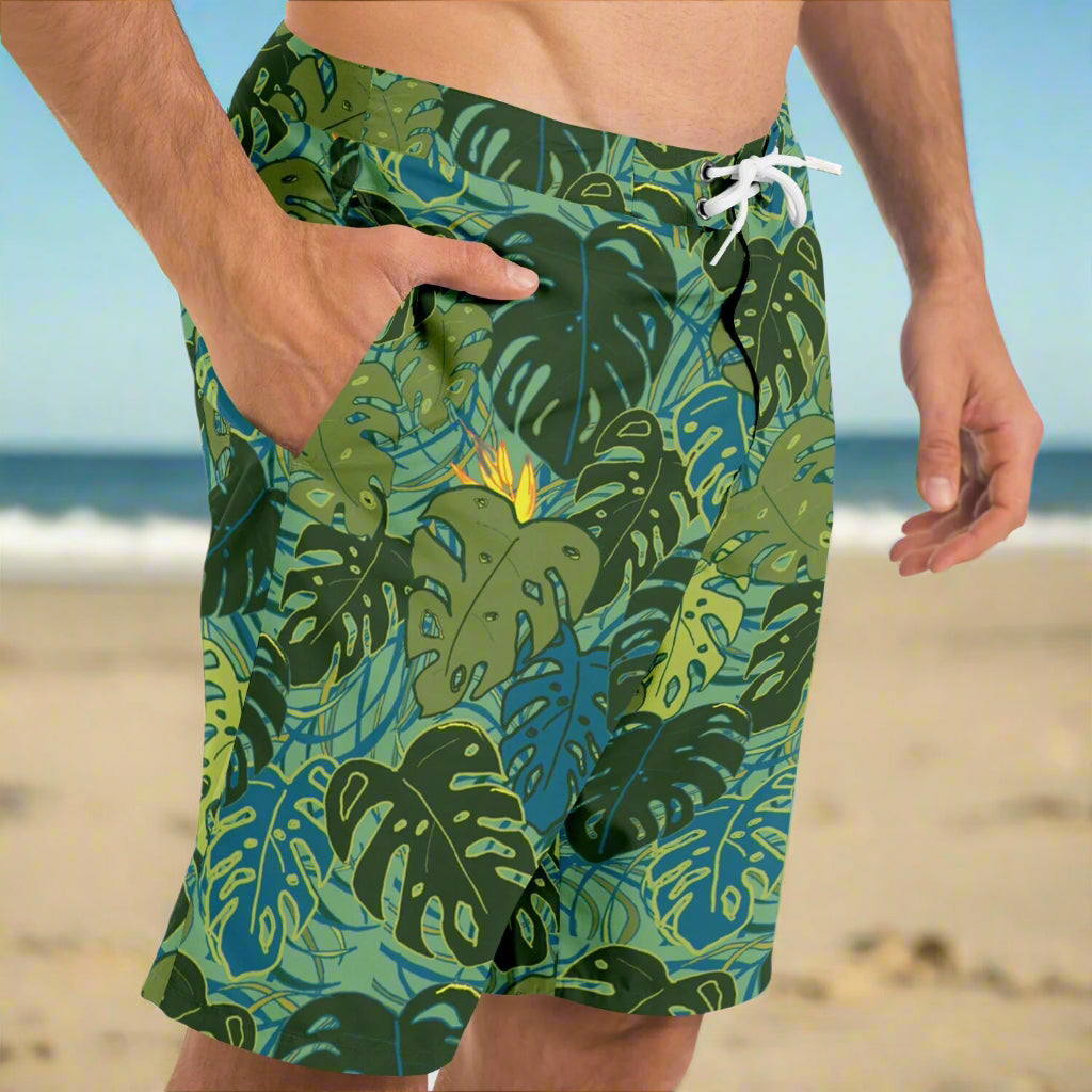Mens board shorts with tropical monstera leaves and bird of paradise flowers