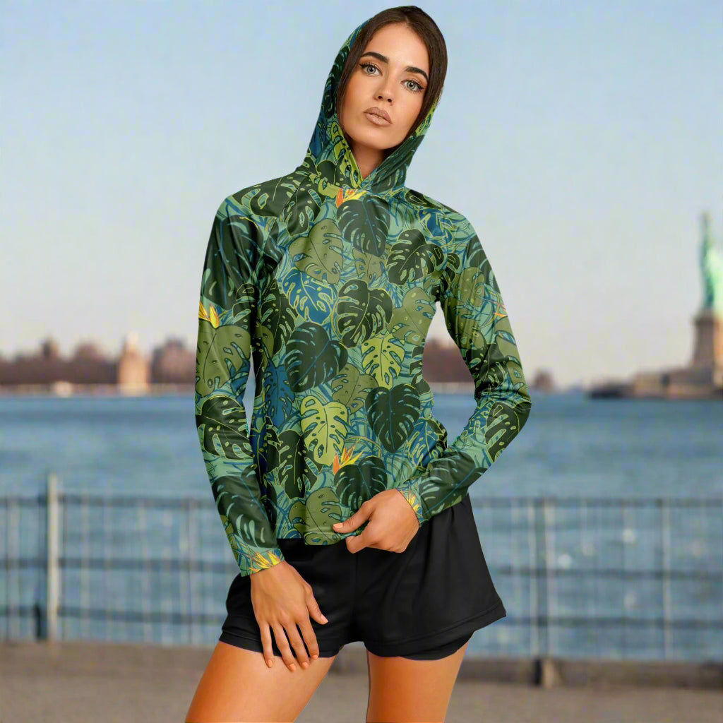 Woman wearing a green leaf-patterned hoodie on a white background