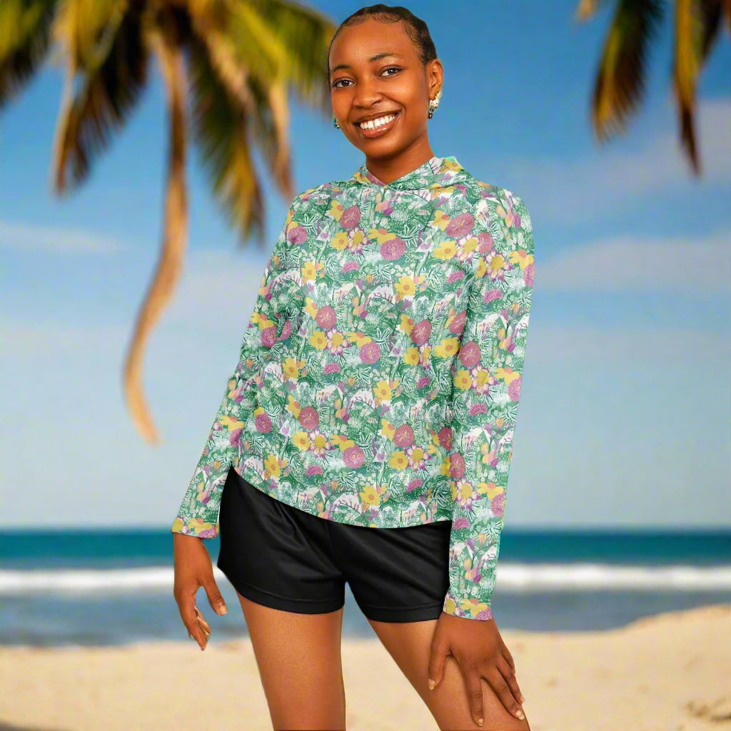Woman wearing a floral long-sleeve shirt and black shorts on a white background