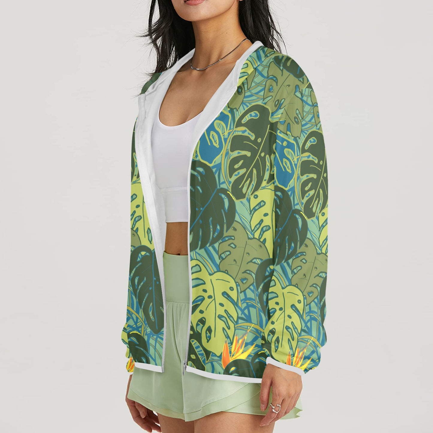 zipped sun hoodie with tropical canopy monstera leaves and bird of paradise front view