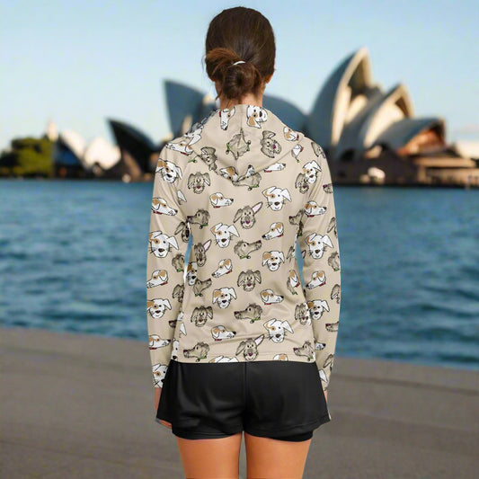 A woman is shown from the back wearing a long-sleeved hoodie with a beige background featuring a pattern of dogs
