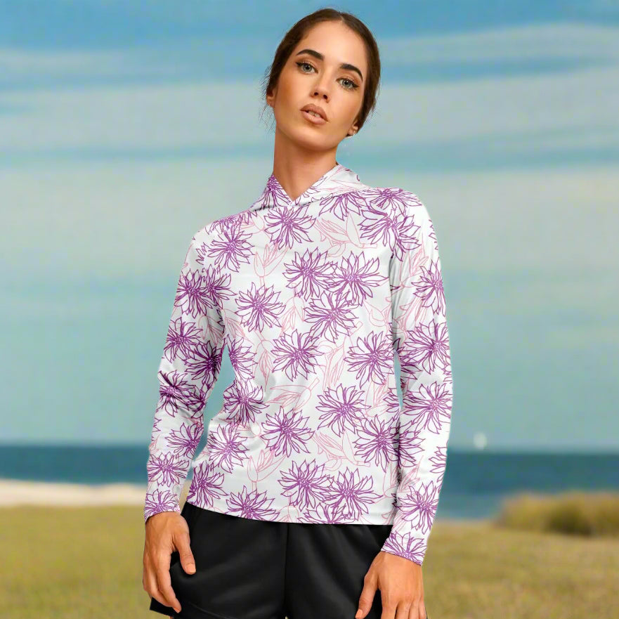 Woman wearing a white hoodie with purple floral patterns and black shorts 