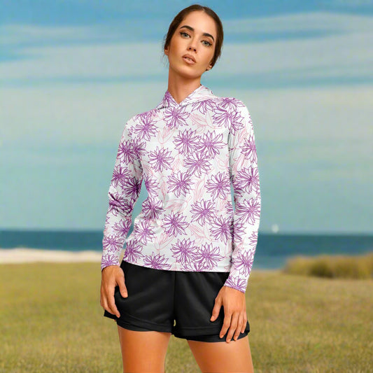 Woman wearing a white hoodie with purple floral patterns and black shorts 