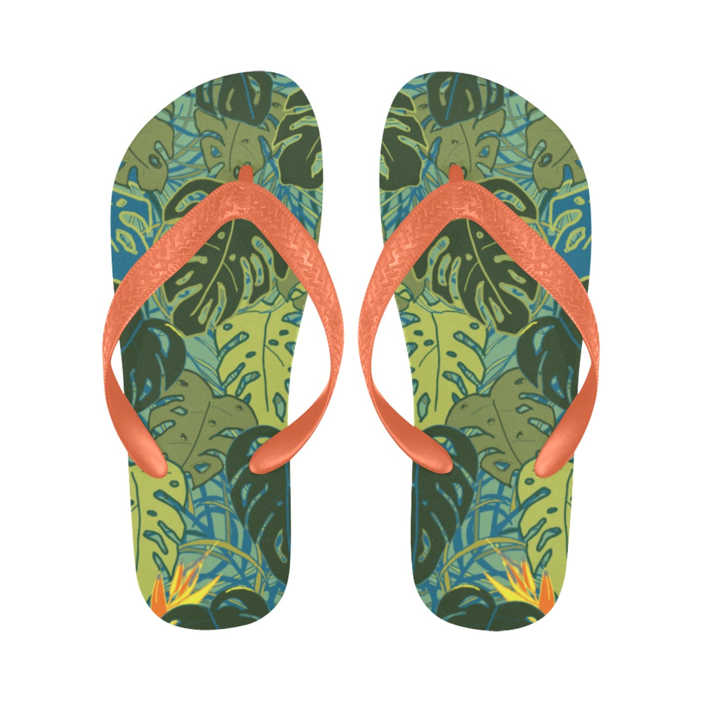 pair of flip flops with tropical canopy monstera leaves and bird of paradise flowers