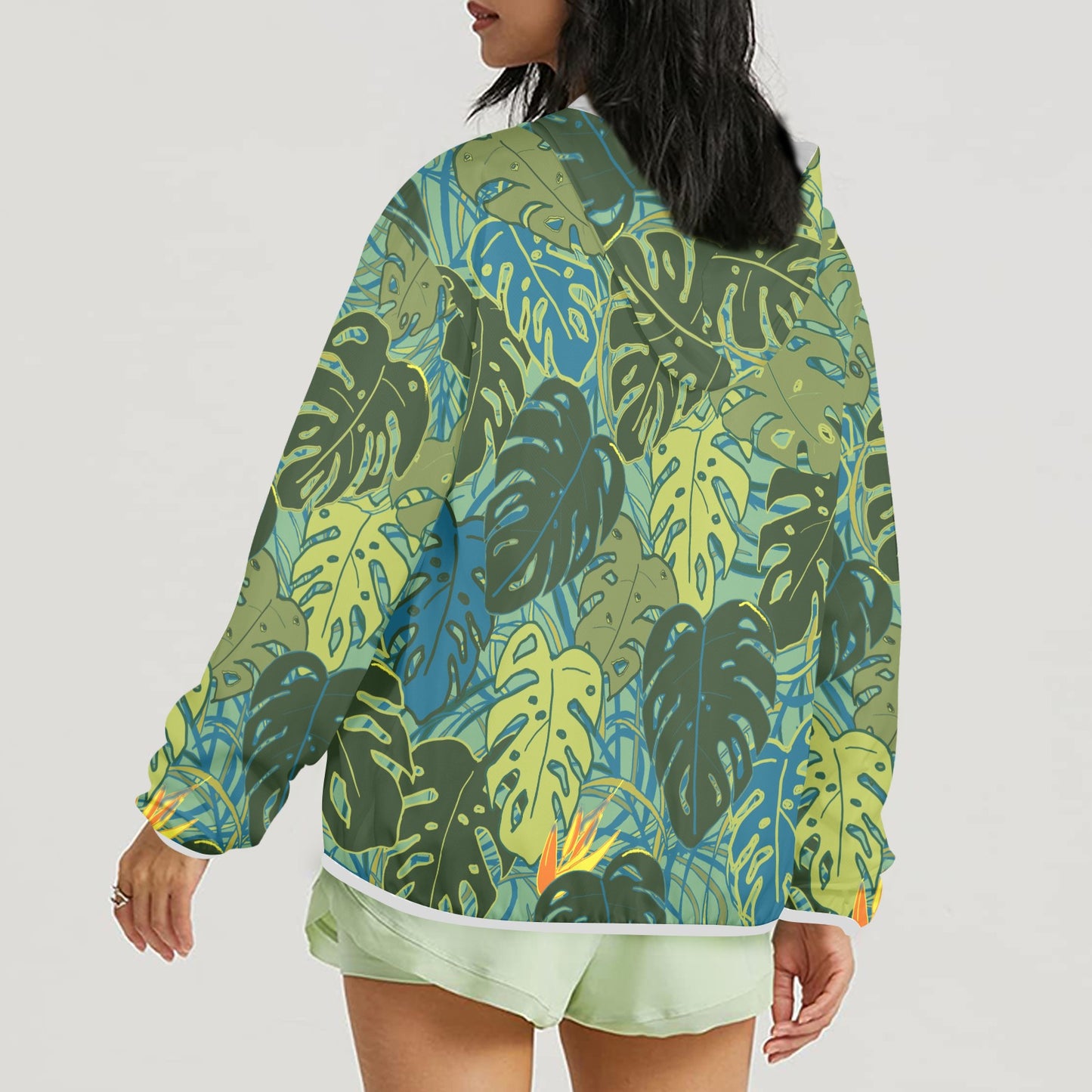 zipped sun hoodie with tropical canopy monstera leaves and bird of paradise back view